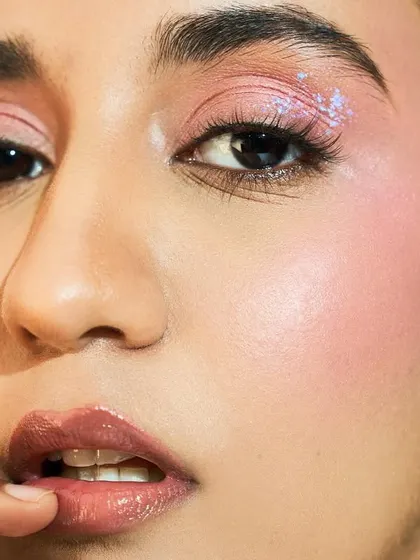 My student Kavi created this look with a touch of iridescent glitter on the cheekbones, showing how to add a creative flair to a classic glowing skin look.
