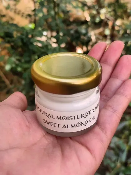 A mini moisturizer jar with sweet almond oil, part of a custom gift set. These little jars are perfect for travel or trying out a new product.