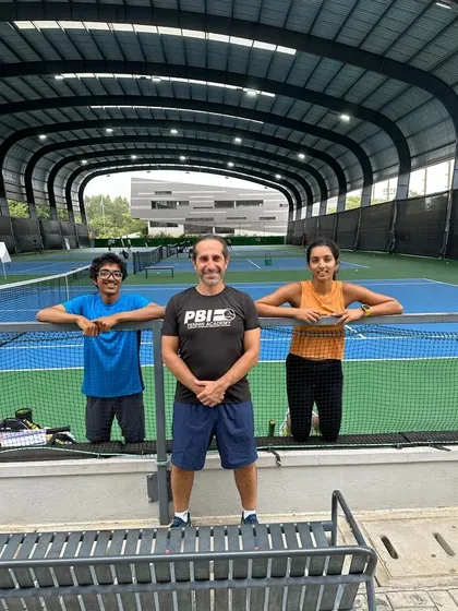A coach with two of our players, reflecting the collaborative and supportive training environment we foster at the academy.