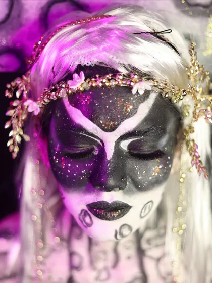 A serene, eyes-closed pose of the moon goddess look, highlighting the glitter and texture on the face.