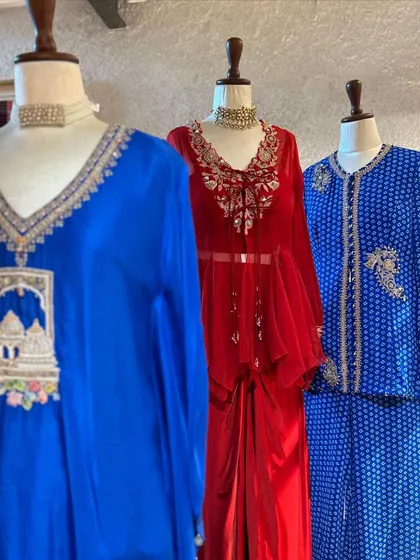 A trio of festive outfits in royal blue and vibrant red. I curate a variety of styles, from draped fusion wear to traditional printed suits, to cater to every taste.