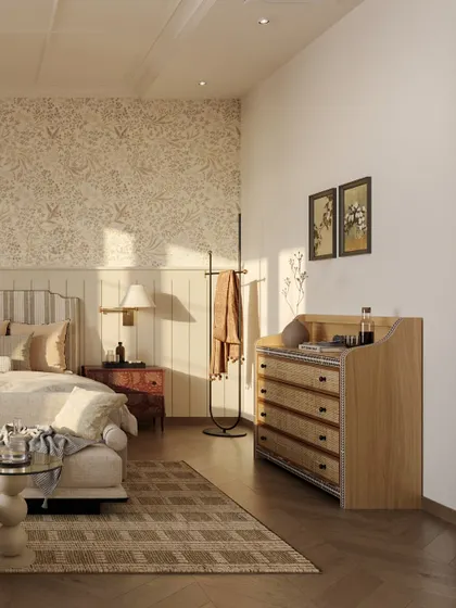 A view of the custom-designed dresser with cane-front drawers, adding a touch of vintage charm. The room is layered with soft wallpaper and paneling to evoke a sense of nostalgia.