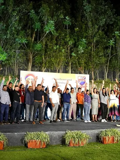 The parents raising their hands and cheering, fully engaged in the celebration.