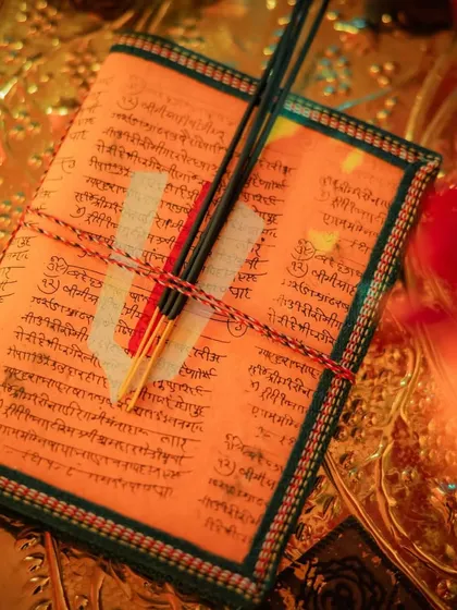 A detail of the personalized prayer books and incense sticks provided to guests at the Sunderkand event, showing my commitment to creating a holistic and thoughtful experience.