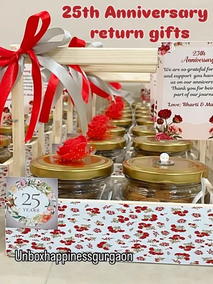 A close-up of a silver jubilee return gift basket, showing the custom '25 Years' tag and the floral-patterned design.