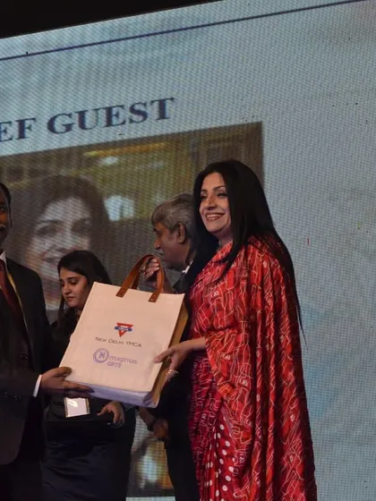 A guest of honor receives a welcome gift bag upon their arrival at the Memorabilia event.