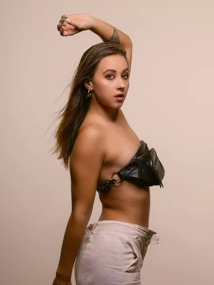 An unconventional fashion portrait where a fanny pack is worn as a top. This creative styling makes for a unique and memorable editorial shot that challenges traditional fashion norms.