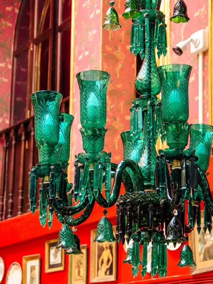 Another view of our unique green glass chandeliers. They are a testament to our commitment to creating a space that is both culturally rich and visually stunning.