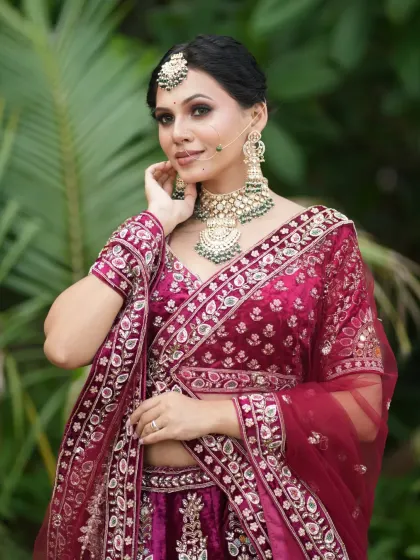 The bride posing gracefully, showing off the full detail of her outfit and jewellery.