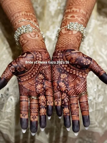 A full view of a bride's intricately detailed palms. The dark, rich stain and the fine lines of the floral and elephant motifs are a testament to the beauty of traditional henna art.