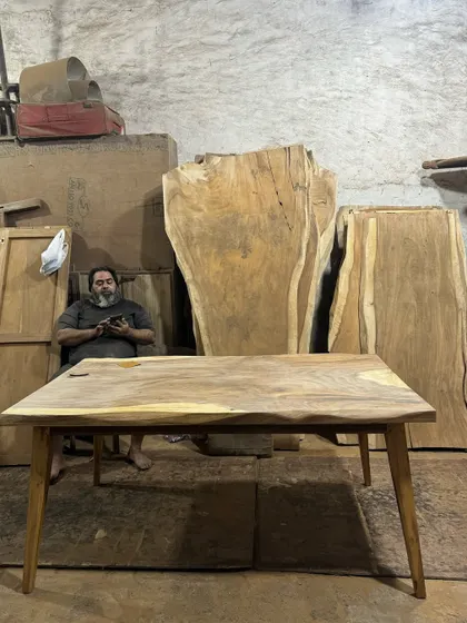 Another shot of the unfinished live-edge table in the workshop, with myself in the background.