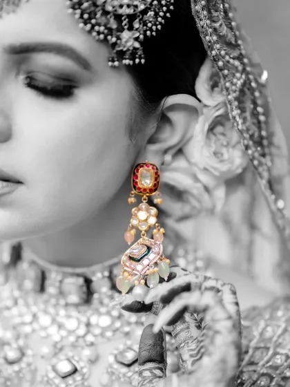 A black and white photo that highlights the beauty of the bride's earring.