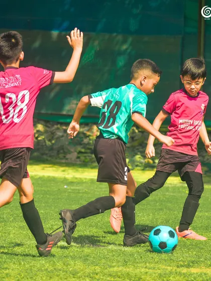 Three of our youngest players chasing the ball with enthusiasm.