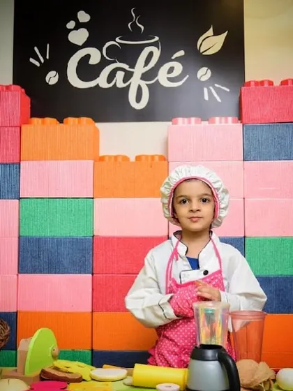 A little chef stands proudly at the counter of our play cafe, ready to take your order.
