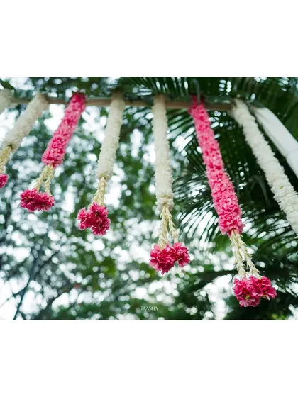 A close-up of the hanging floral garlands, a beautiful and traditional element of the entrance decor.