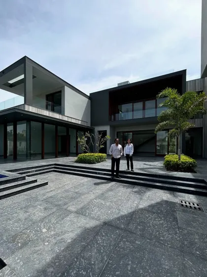 Another perspective of the co-founders at Rosewood Farmhouse, showcasing the grand, multi-level courtyard that serves as the primary outdoor living and circulation space for the home.