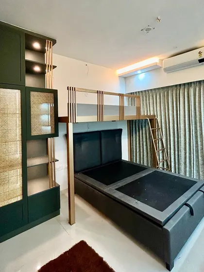 A completed loft bed in a kid's room, a fantastic way to free up floor space by combining the sleeping area with storage or a study nook below.