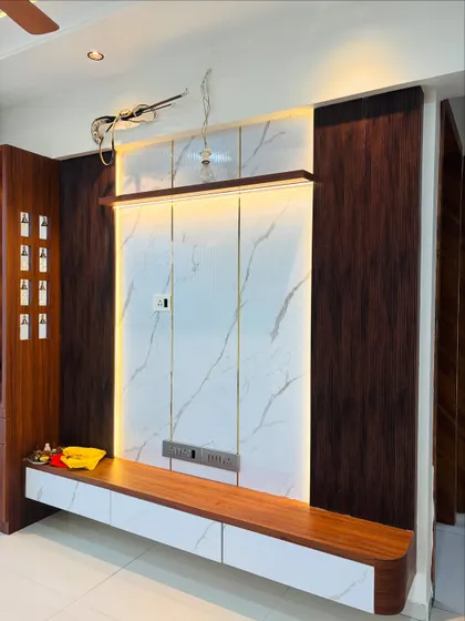 This TV unit combines dark wood with a white marble-finish laminate and is backlit to create a floating effect. The design is modern, clean, and provides ample storage with its wide console.