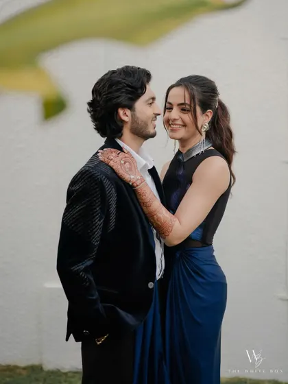 A sweet moment between the couple. Her cocktail look features a bold ombré liner, but her skin is kept fresh and glowing, letting her happiness shine.