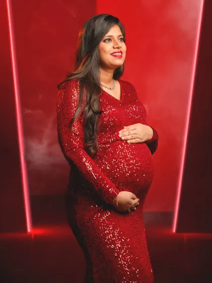 A radiant portrait capturing the joyful anticipation of a mom-to-be, beautifully lit in our modern studio setup.