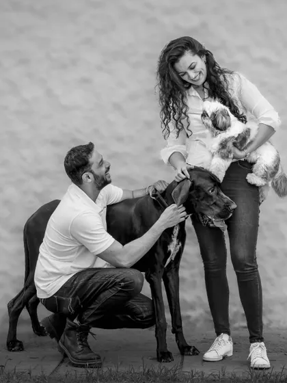 The 'big meets small' family portrait in classic black and white. This timeless style focuses on the emotional connection and the different textures of the scene.