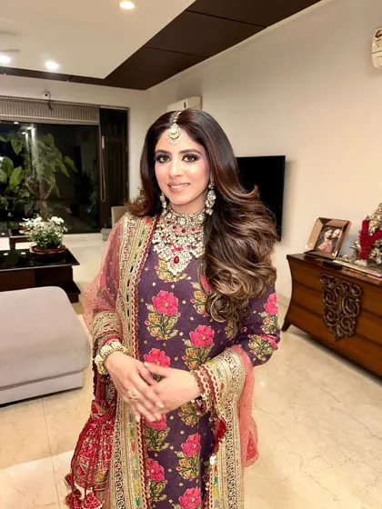 For a client attending a wedding, I created these voluminous, soft curls to complement her traditional Sabyasachi suit.
