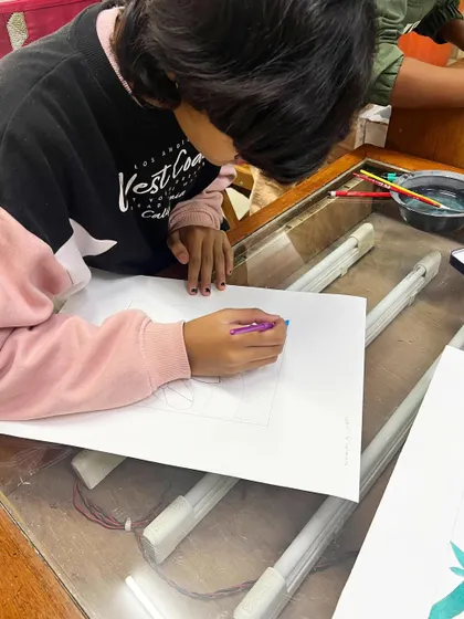 Students at our silkscreen workshop focused on preparing their designs by blocking out colors on paper.