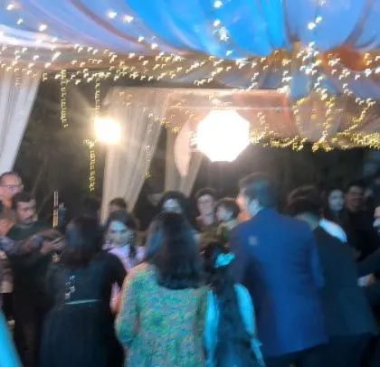 The dance floor is packed with happy guests.