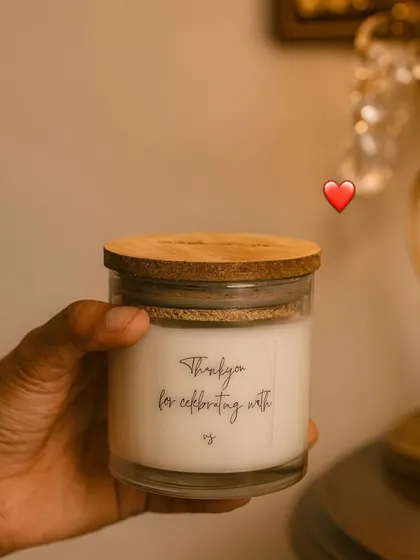A candle perfect for all occasions. This simple glass jar candle with a wooden lid says 'Thank you for celebrating with us,' a small token of love for the people who matter.