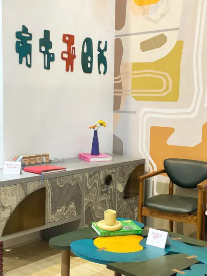 A vibrant corner from an exhibition, featuring our "Doodle" coffee table and a unique sideboard. This image captures the playful and artistic vibe of our brand.