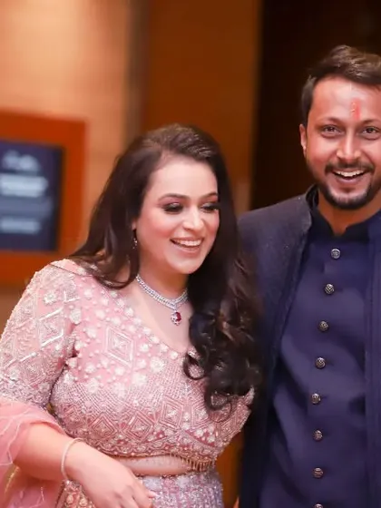 The colour version of a happy, candid moment. The couple's joyful laughter is infectious in this shot from their engagement party.