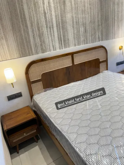A close-up of the mid-century modern bed with a distinctive cane and solid wood panelled headboard. The matching nightstand with its clean lines and tapered legs completes the look.