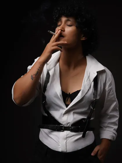 A moody, cinematic portrait from my 'Leather straps and Cigarettes' series. This demonstrates my conceptual work, using dramatic lighting and styling to tell a story.