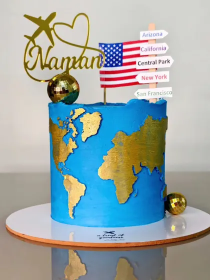 A bon voyage cake for someone heading to the USA. I created a world map in gold on blue buttercream and added a custom topper with a list of destinations.