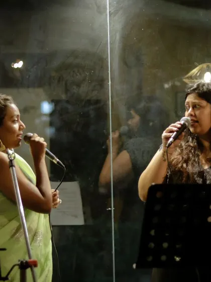 The magic of a duet. Here, two vocalists from the 90's Jukebox showcase fill the room with incredible harmonies during their energetic Bollywood performance.