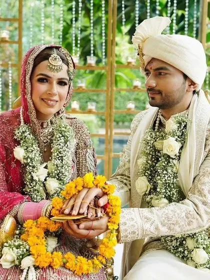 The couple performing a wedding ritual together.