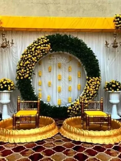 I love creating vibrant and grand setups for Haldi ceremonies. This design uses a massive ring of marigolds and lush greens to create a spectacular focal point for your celebration.