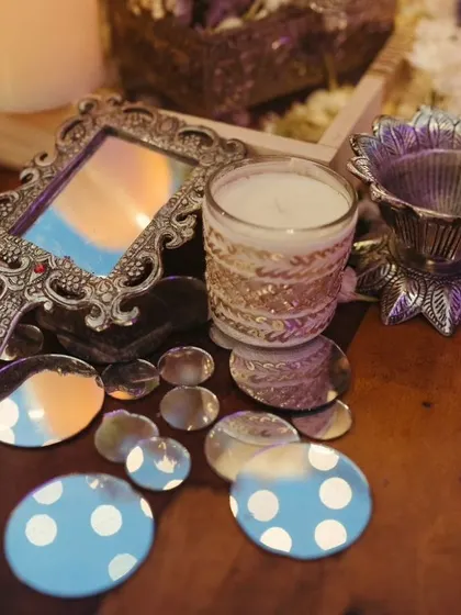 Eclectic decor elements like vintage hand mirrors and scattered mirror pieces on a wooden table, adding a touch of antique charm to the Sufi night ambiance.