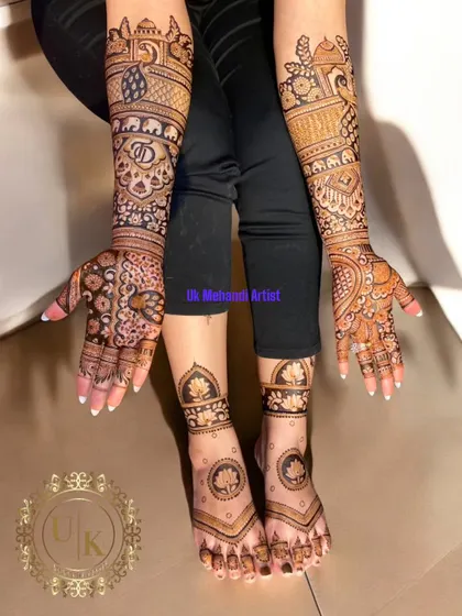 A complete bridal look with henna on both hands and feet. The feet feature a simple yet elegant lotus design that complements the more intricate work on the hands.