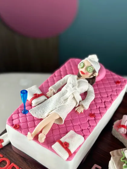 Fabulous, fierce, and finally forty. This cake celebrates the big 4-0 in the most relaxing way possible, with a spa day theme complete with a fondant figure, cucumber eyes, and champagne.
