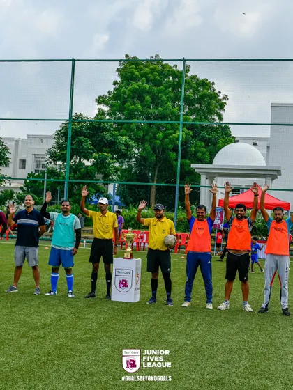 A team waves to the camera, ready for their day of football. The excitement and anticipation before the first whistle are always high.