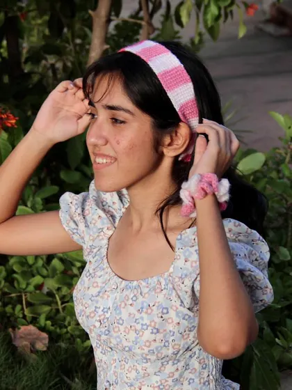 Adjusting the pink headband. It’s made with soft cotton yarn that has a bit of stretch for a perfect fit.