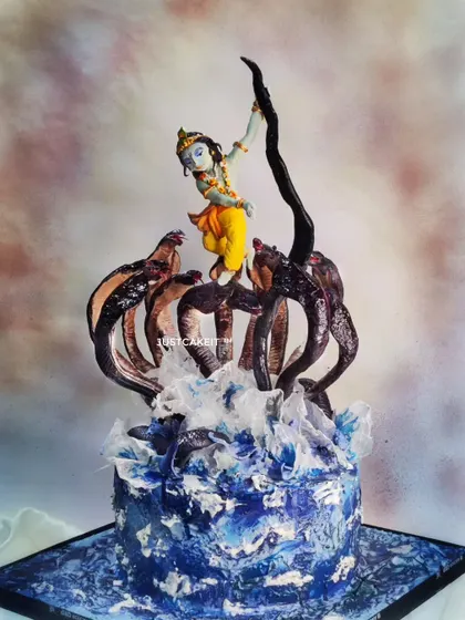 My award-winning 'Krishna dancing on Kaaliya Naag' cake is a piece of devotional art. The entire dynamic scene, including Krishna's pose and the splashing water of the Yamuna, is hand-molded and painted to capture a divine moment.