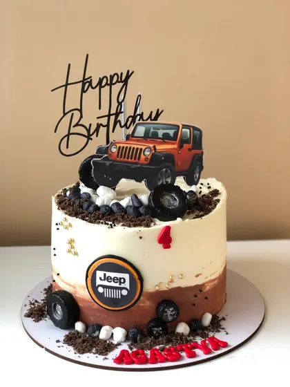 An off-road adventure cake featuring a Jeep topper, chocolate "mud," and rocky details.