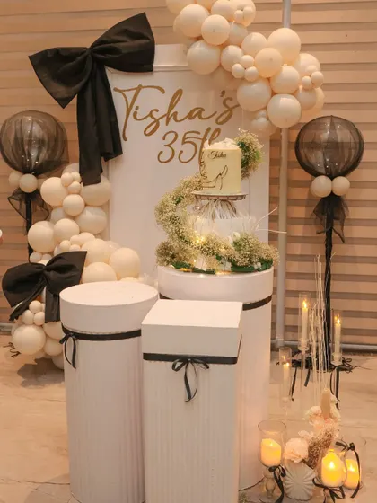 Another angle of the cake and dessert station, showing the transparent balloons with black accents that complement the theme.