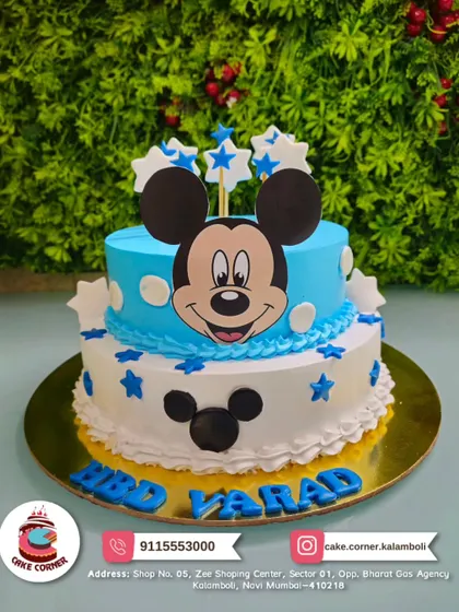 Oh, boy! A two-tier Mickey Mouse cake in blue and white, decorated with stars. It's a cheerful and classic design for a young fan's birthday.