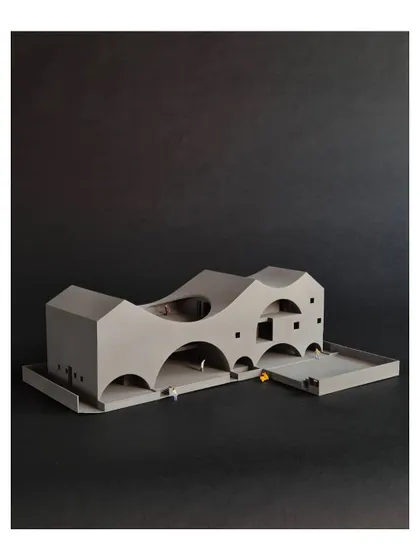 This 3D printed model of 'The Arcades Project' shows our process of reinterpreting familiar forms. Arches and pitched roofs are used in unconventional ways to create a compact community center that feels light and open.