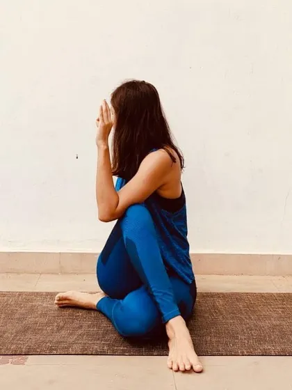 This is Ardha Matsyendrasana, a seated spinal twist that is wonderful for stimulating digestion and energizing the spine. It also provides a deep stretch for the shoulders, hips, and neck, helping to relieve backache and fatigue. I always offer modifications to make it accessible for everyone.