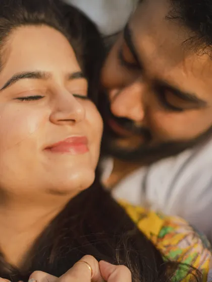 A soft and dreamy close-up, capturing the groom whispering to the bride, a moment of pure intimacy.