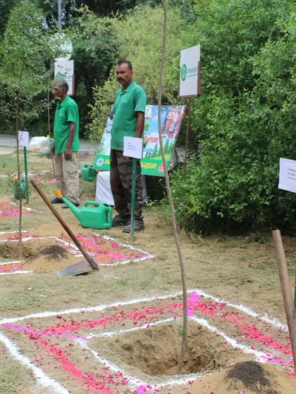 Our on-ground team stands ready with freshly prepared pits, decorated with rangoli, for a ceremonial planting event at the Badshahpur Forest Corridor.